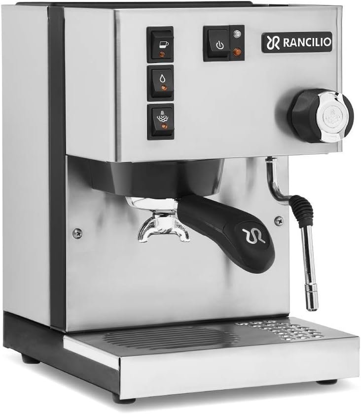 "A front-angled view of a Rancilio Silvia espresso machine featuring a brushed stainless steel body. The machine includes a professional portafilter, a chrome steam wand, three rocker switches for brewing and steam, and a large black steam control knob on the right."